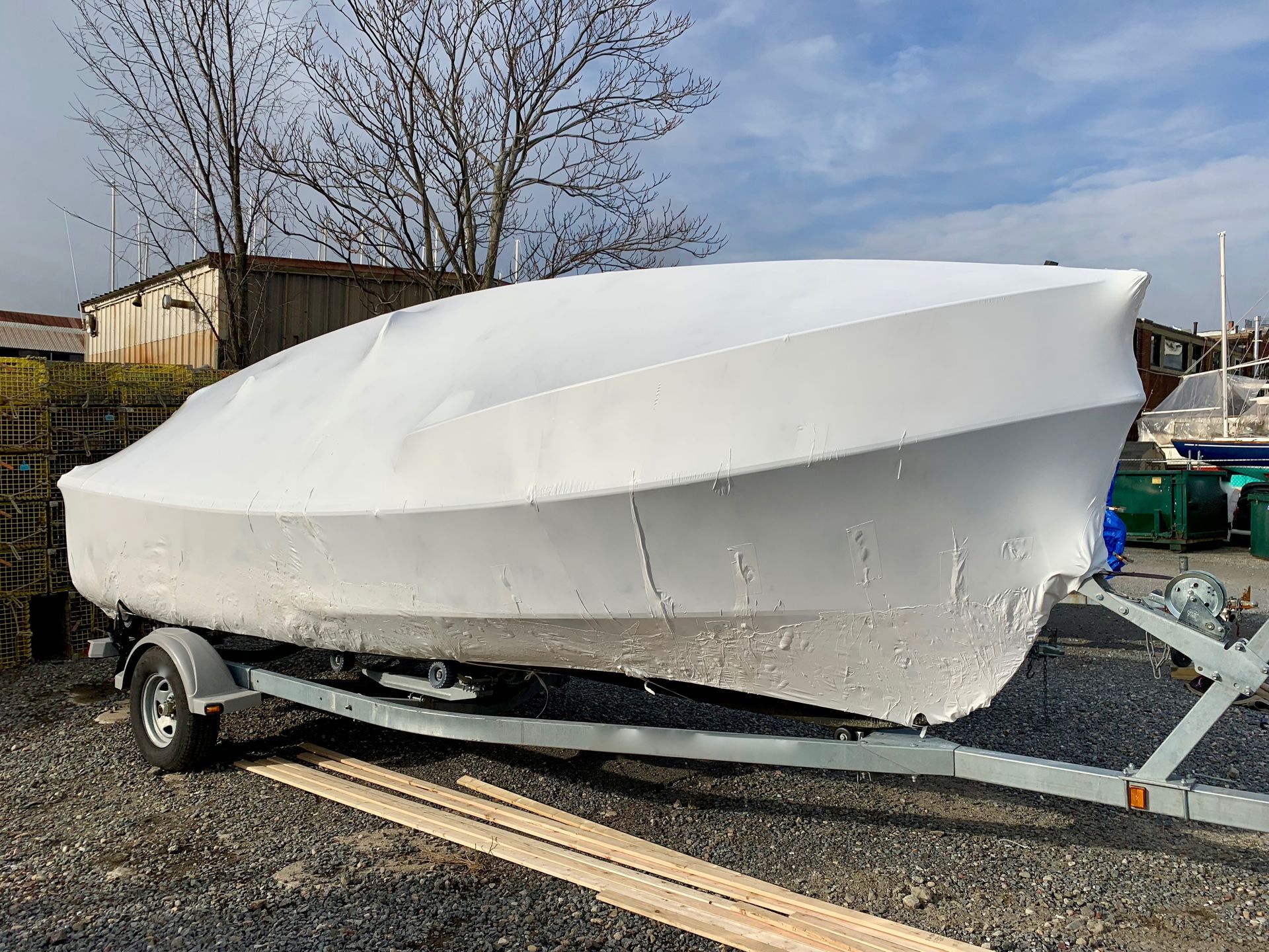 A white boat is sitting on top of a trailer.