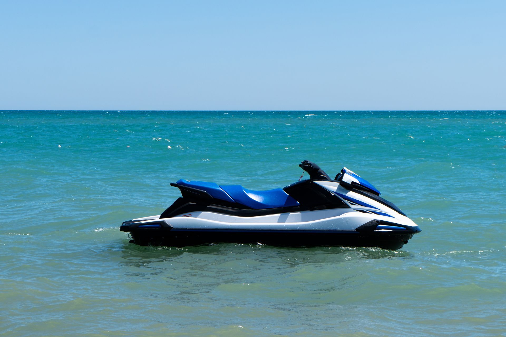 A blue and white jet ski in the ocean