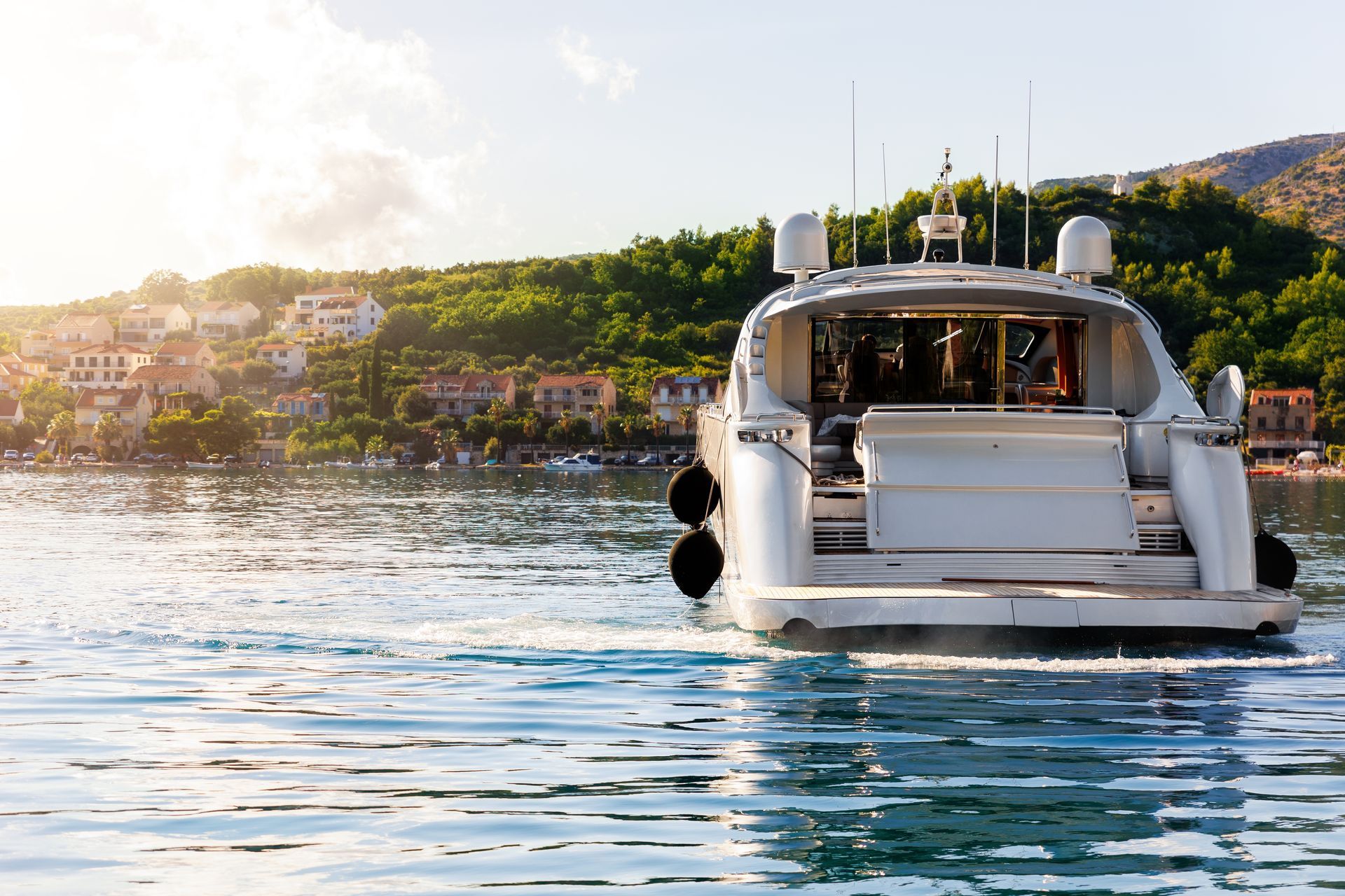 A large white yacht is floating on top of a body of water.