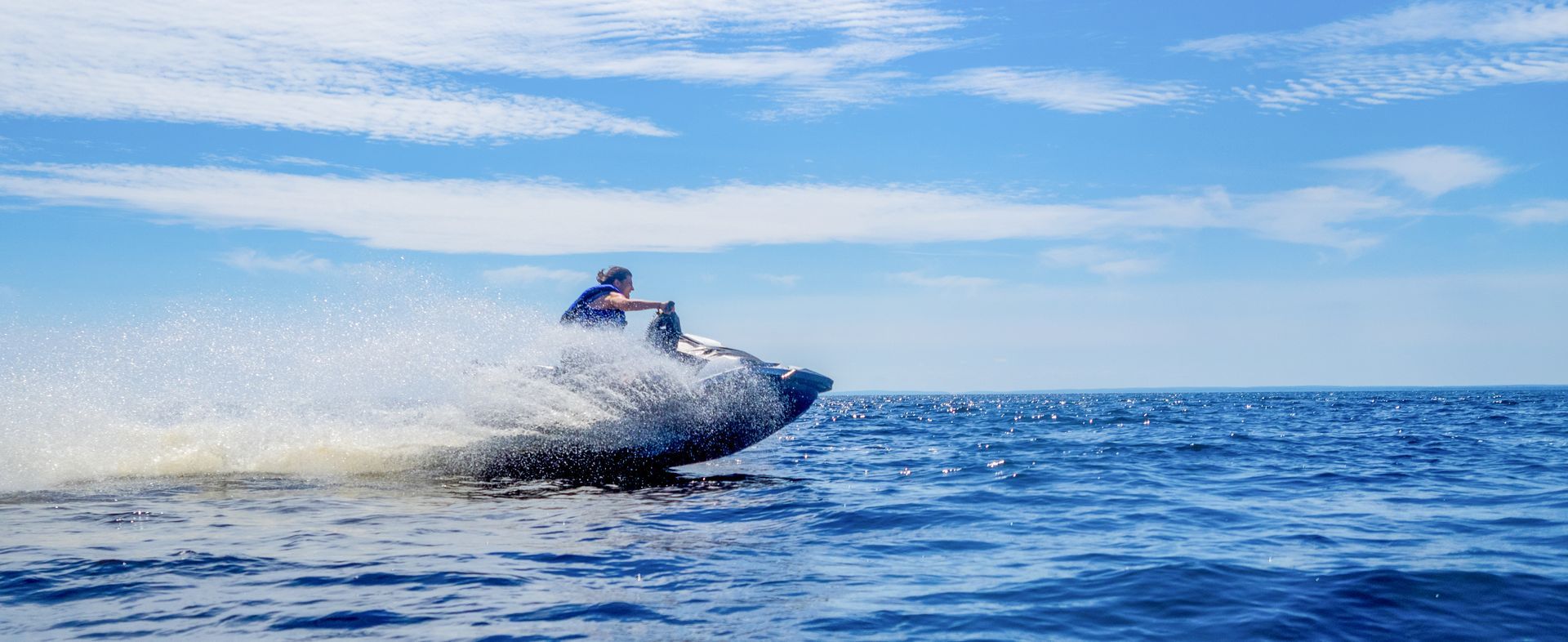 A man is riding a jet ski in the ocean.