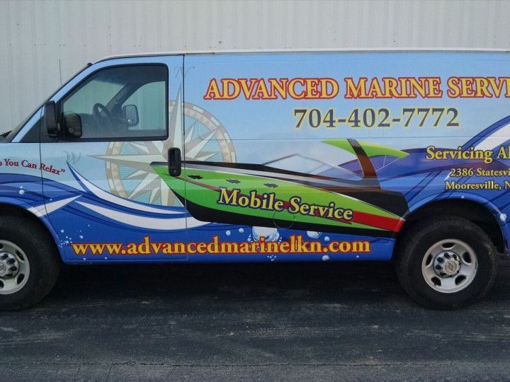 A blue van with advanced marine service written on it