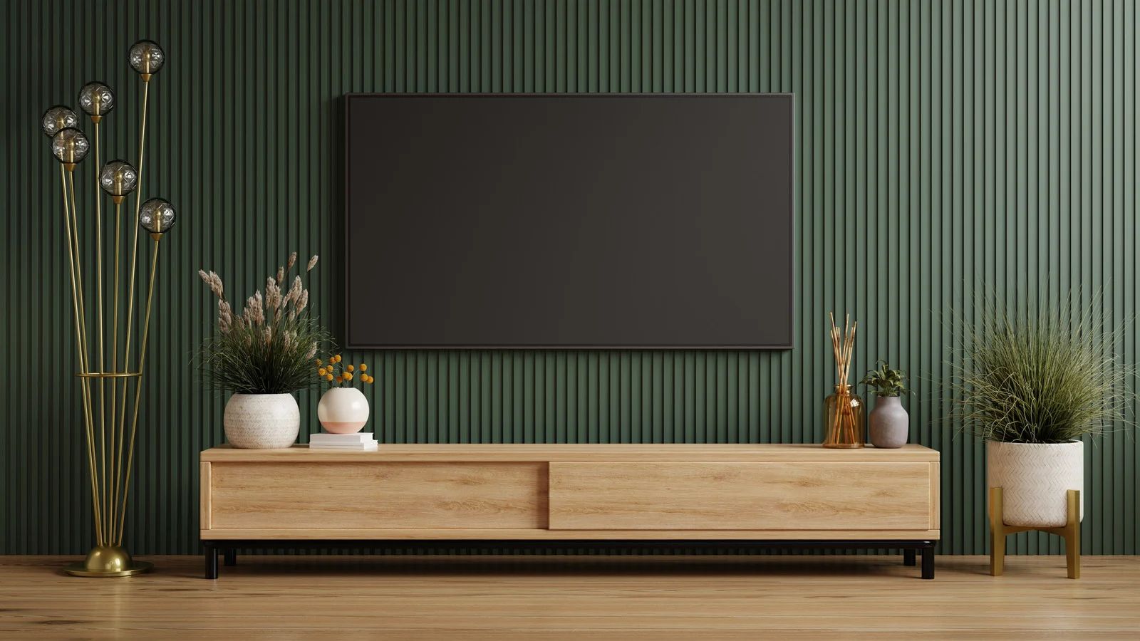Wooden entertainment center with TV on green paneled wall; plants and decorative items.