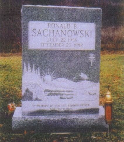 Gravestone of Ronald B. Sachanowski, with his name, birth/death dates, a landscape carving, and a cross.