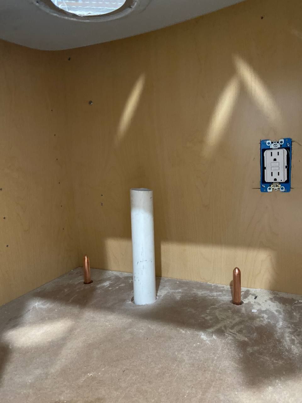 An empty room with a blue box on the wall that says ' electrical ' on it