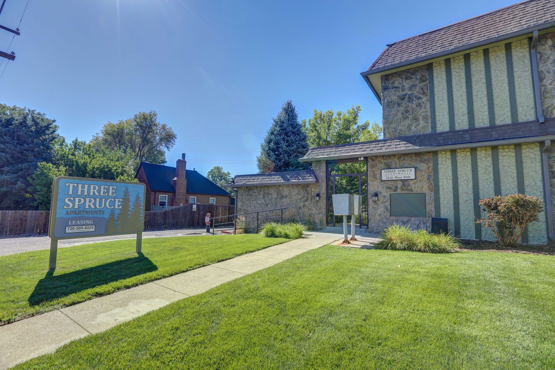 A house with a sign in front of it that says `` three spruce ''.