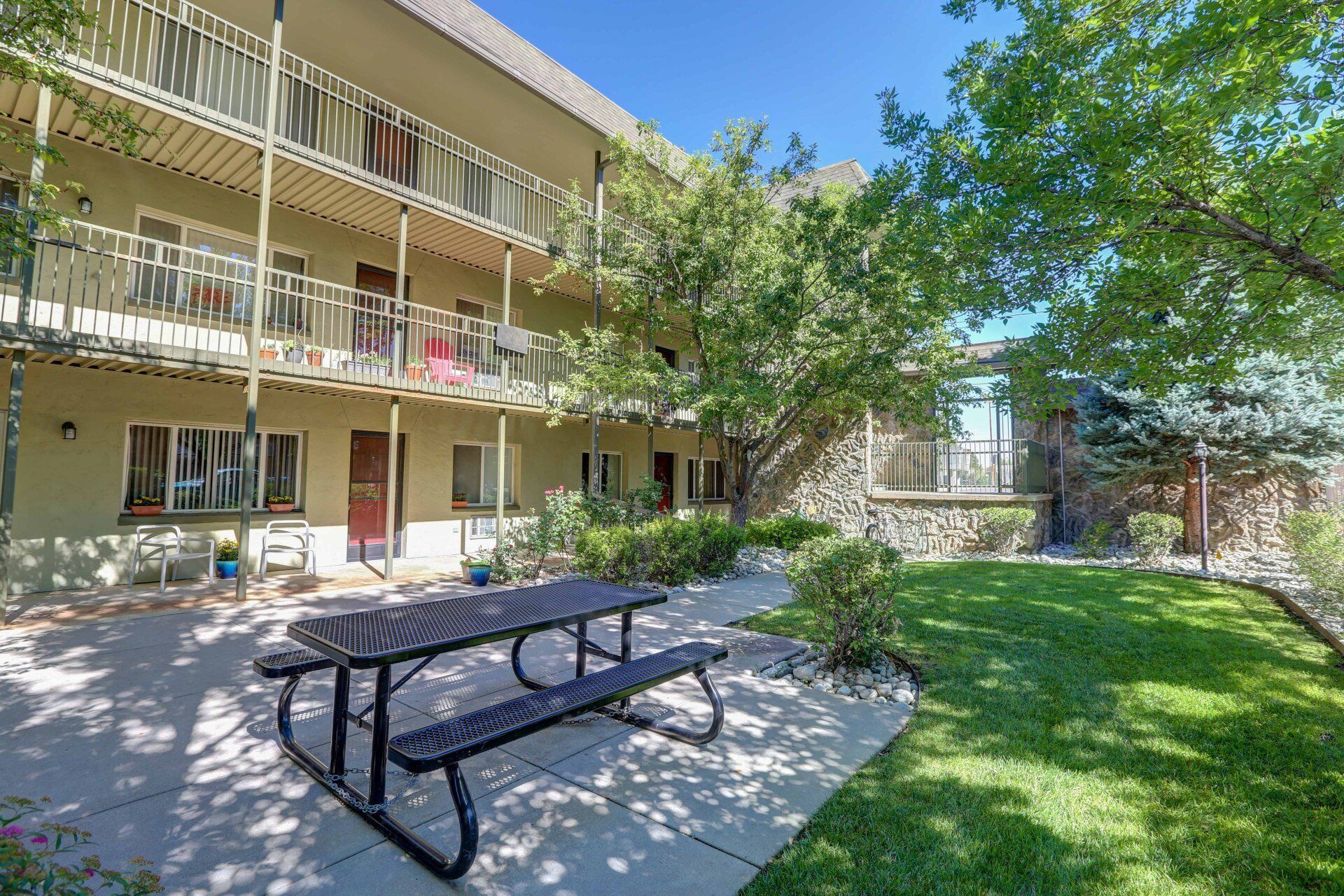 A picnic table is sitting in front of a building.