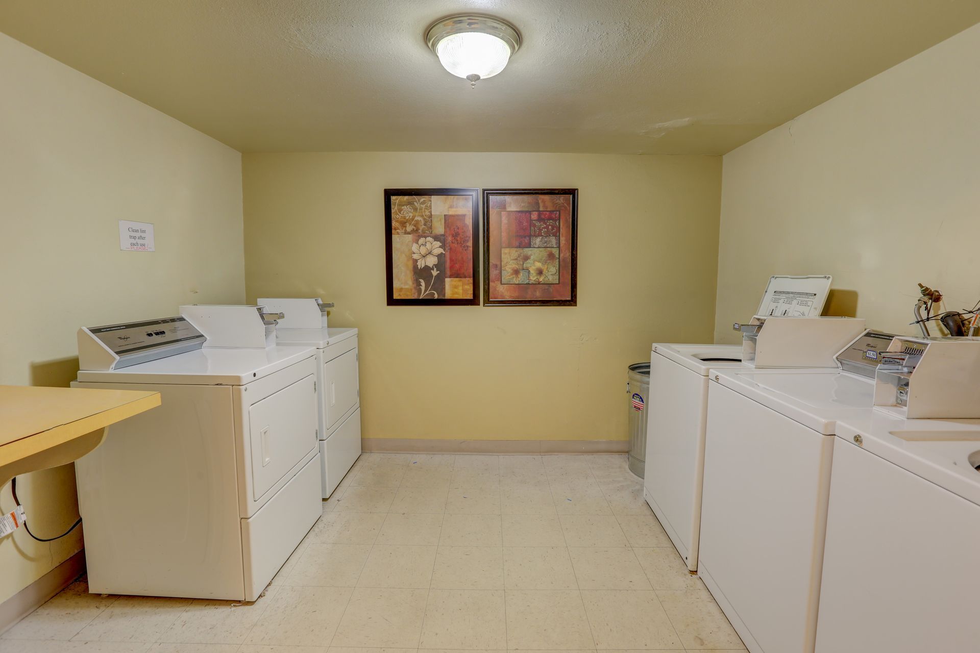 A laundry room with a lot of washers and dryers