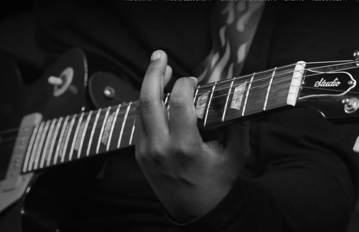 Professional guitar instructor demonstrating advanced fretboard technique in Little Rock, Arkansas.