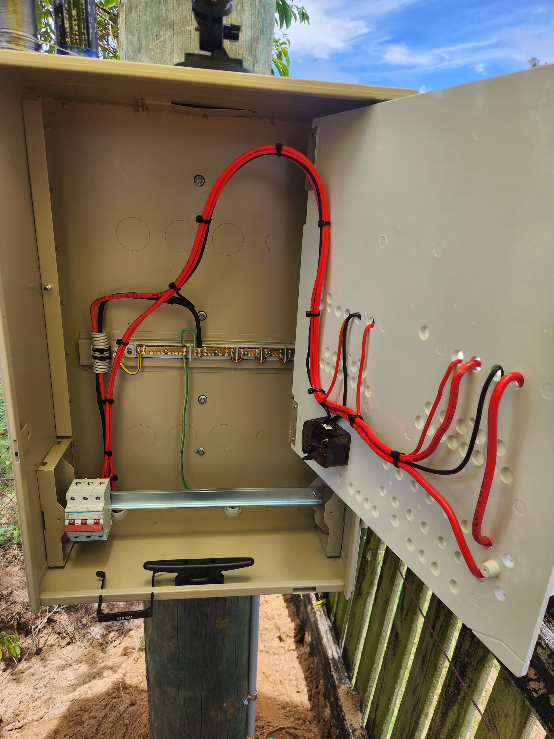 A Post With A Bunch Of Electrical Equipment On It — Prowire Services In Mackay, QLD