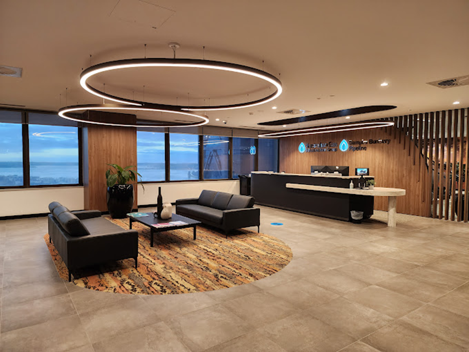 Modern Office Reception Area With Seating, Desk, and Large Round Lights — Perth Electrical & Data in Joondalup, WA