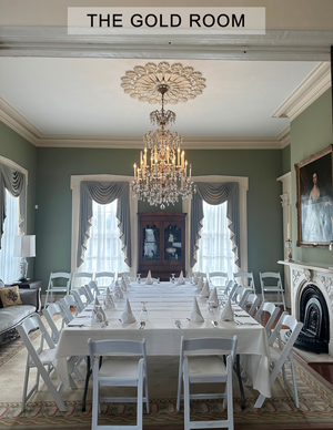 A large room with a table and chairs and a sign that says the gold room