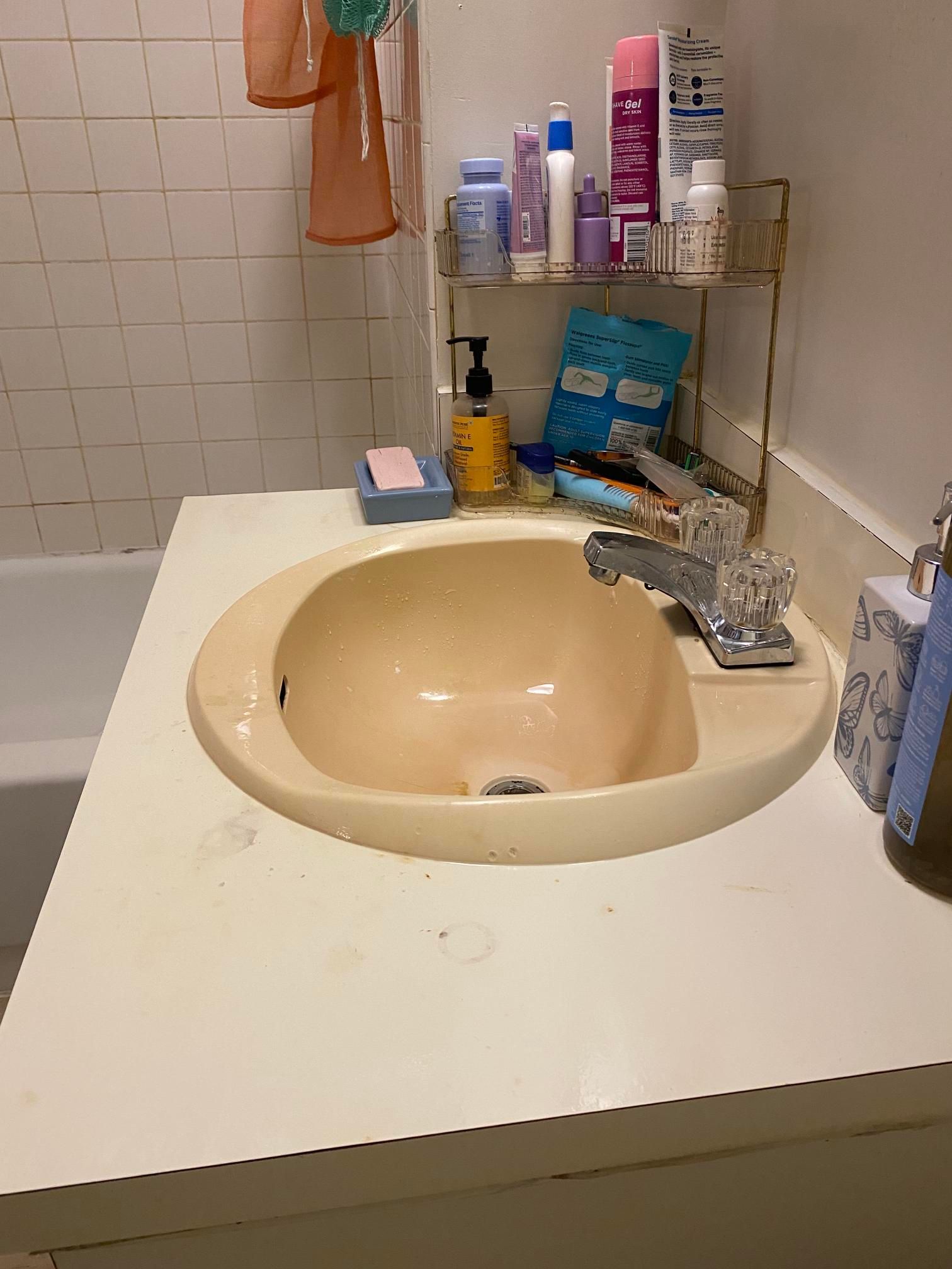 Modern glass shower enclosure with chrome fixtures in a gray tiled bathroom