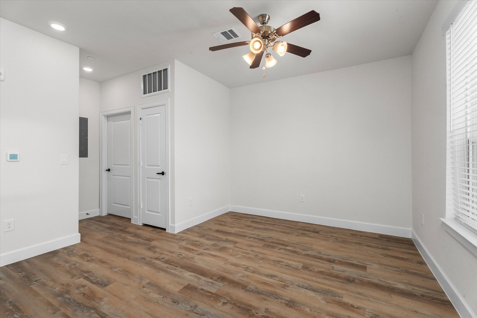 Unfurnished apartment bedroom with wood-style flooring at Cottage Green Simpsonville