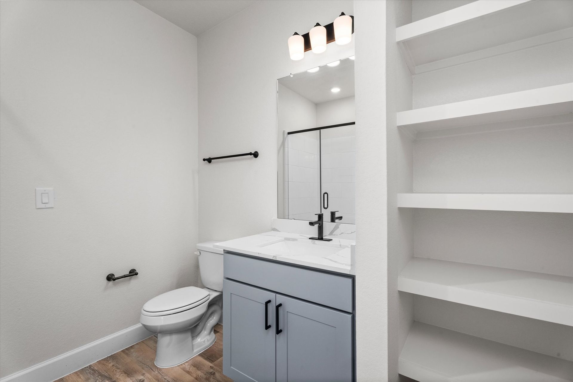 Modern apartment bathroom with vanity and built-in storage at Cottage Green Simpsonville