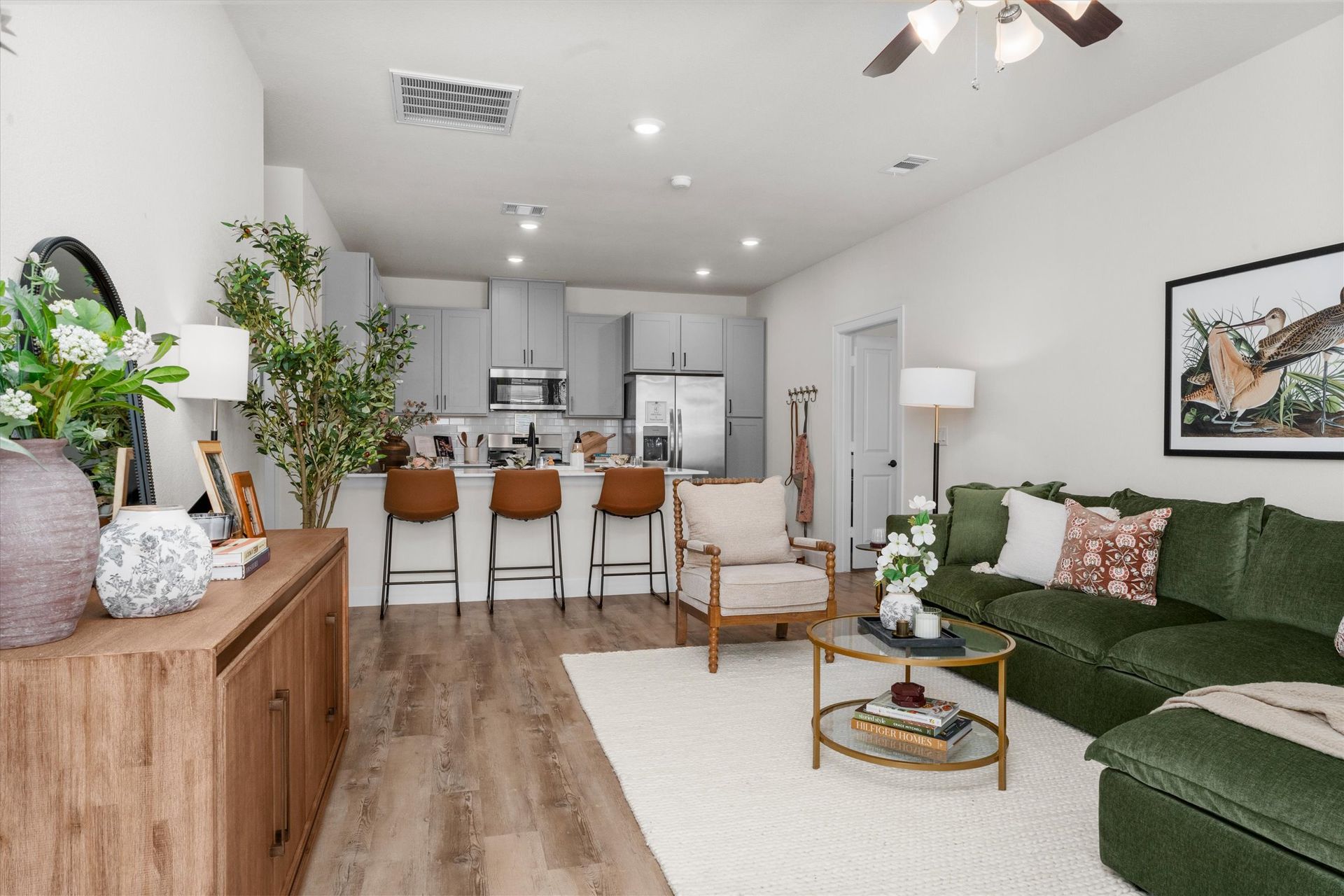 Furnished open-concept living room and kitchen at Cottage Green Simpsonville apartments