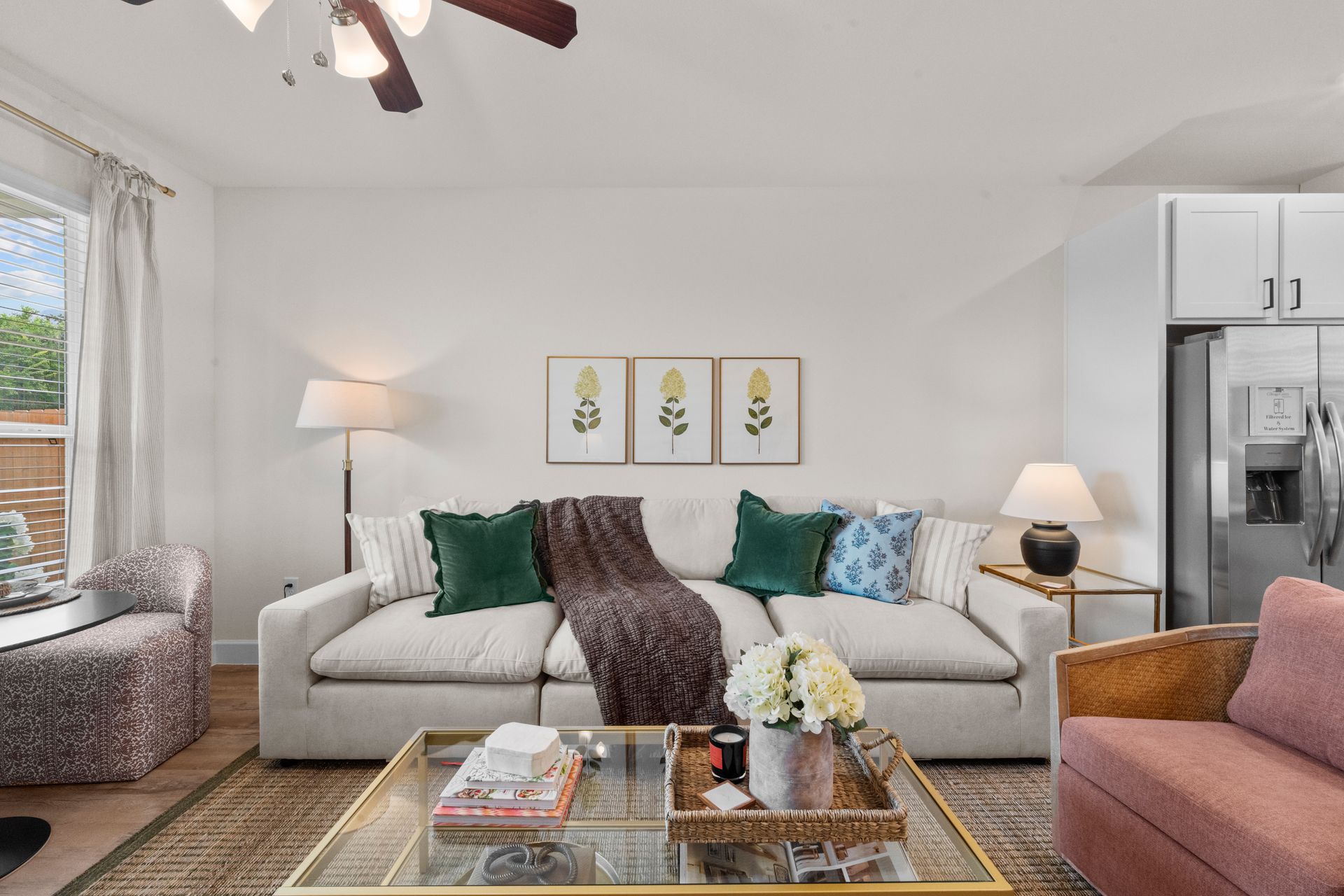 Bright cottage-style living room with large windows at Cottage Green Simpsonville