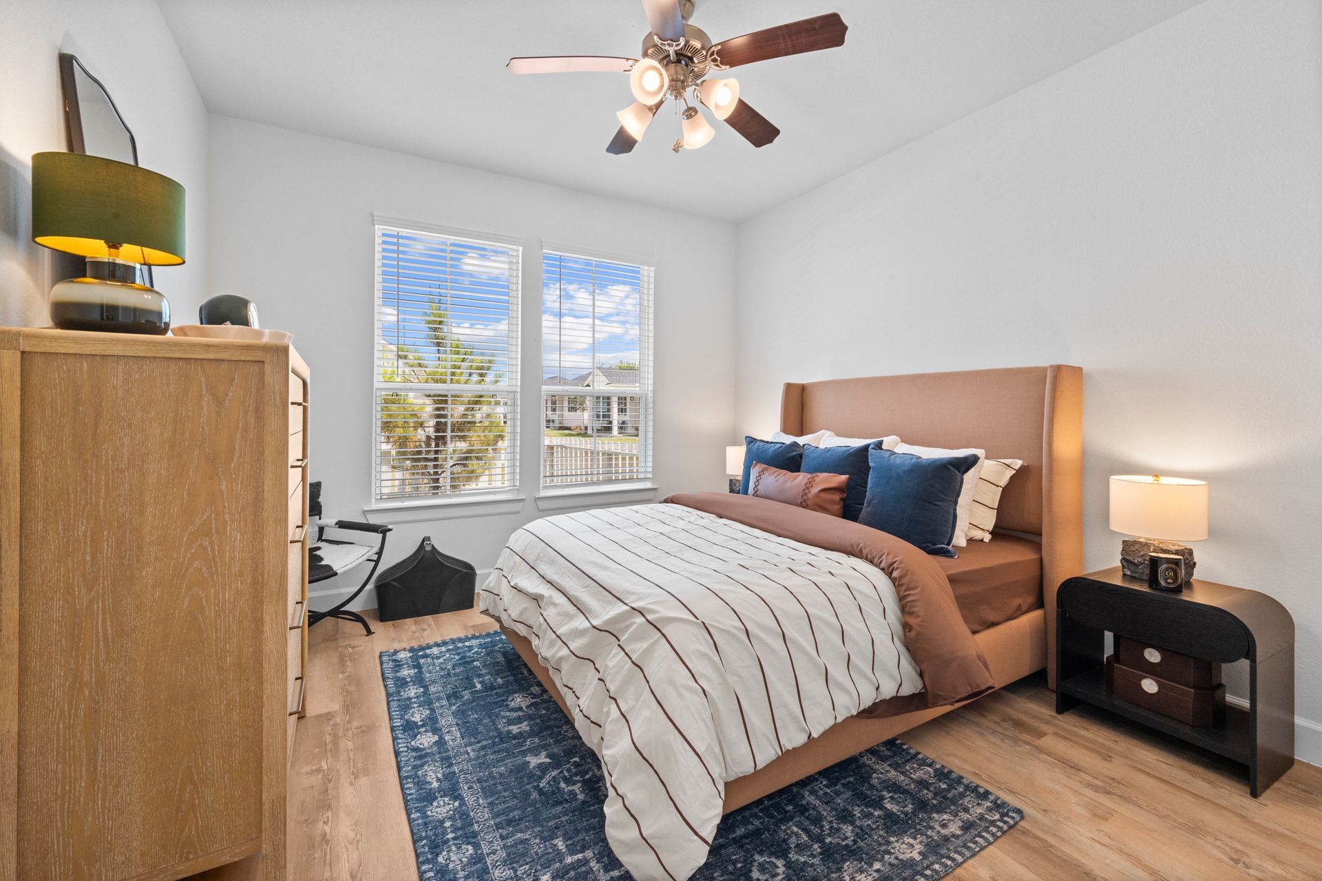 Furnished cottage-style bedroom with large window at Cottage Green Simpsonville