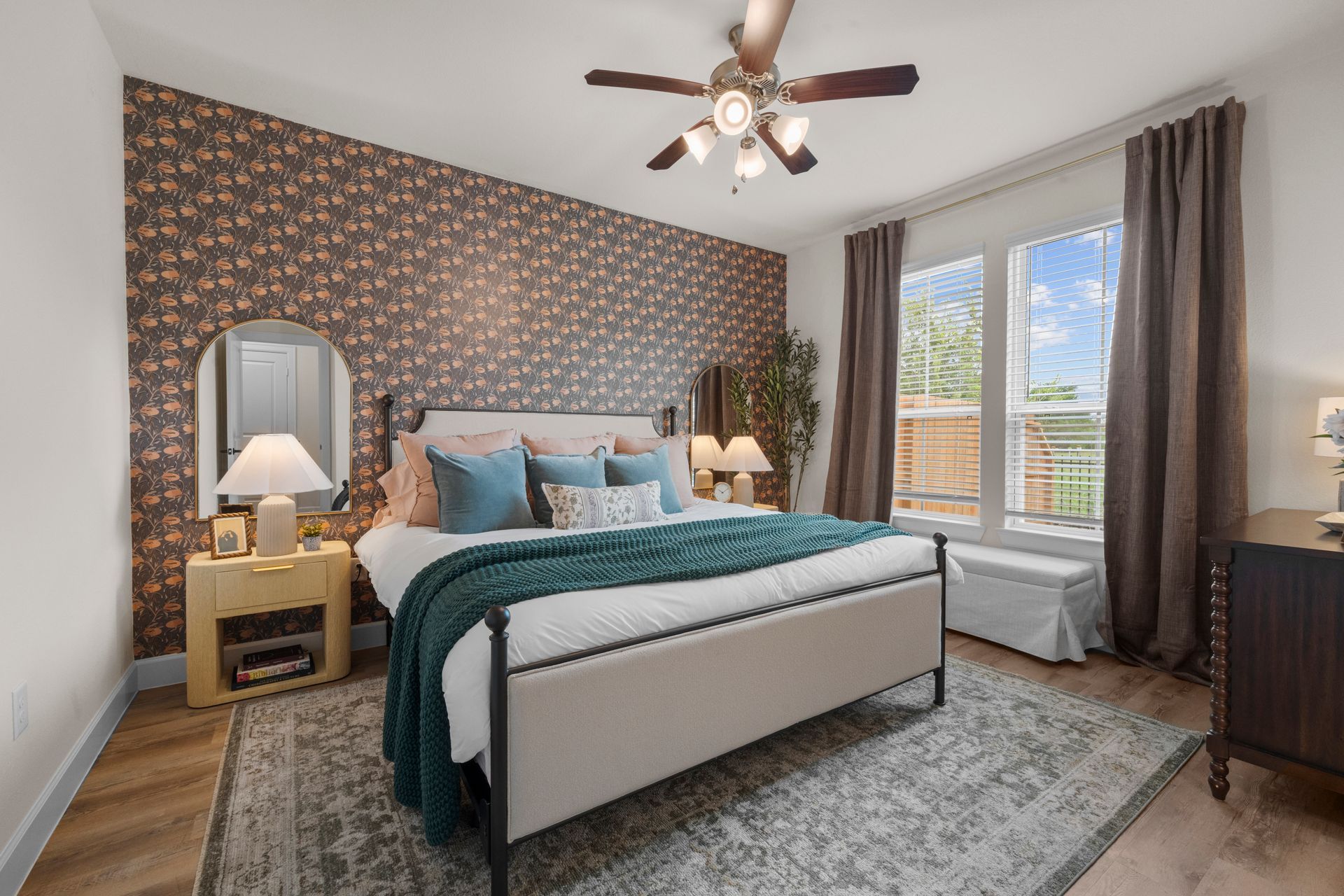 Spacious cottage-style bedroom with accent wall and large windows at Cottage Green Simpsonville