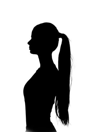 Silhouette of a person in profile with a ponytail against a white background