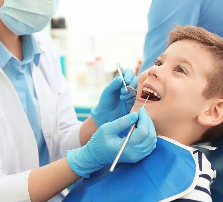 A Young Boy is Getting His Teeth Examined by a Dentist — Bytes of Byron–Bio Holistic Dentistry in Byron Bay, NSW