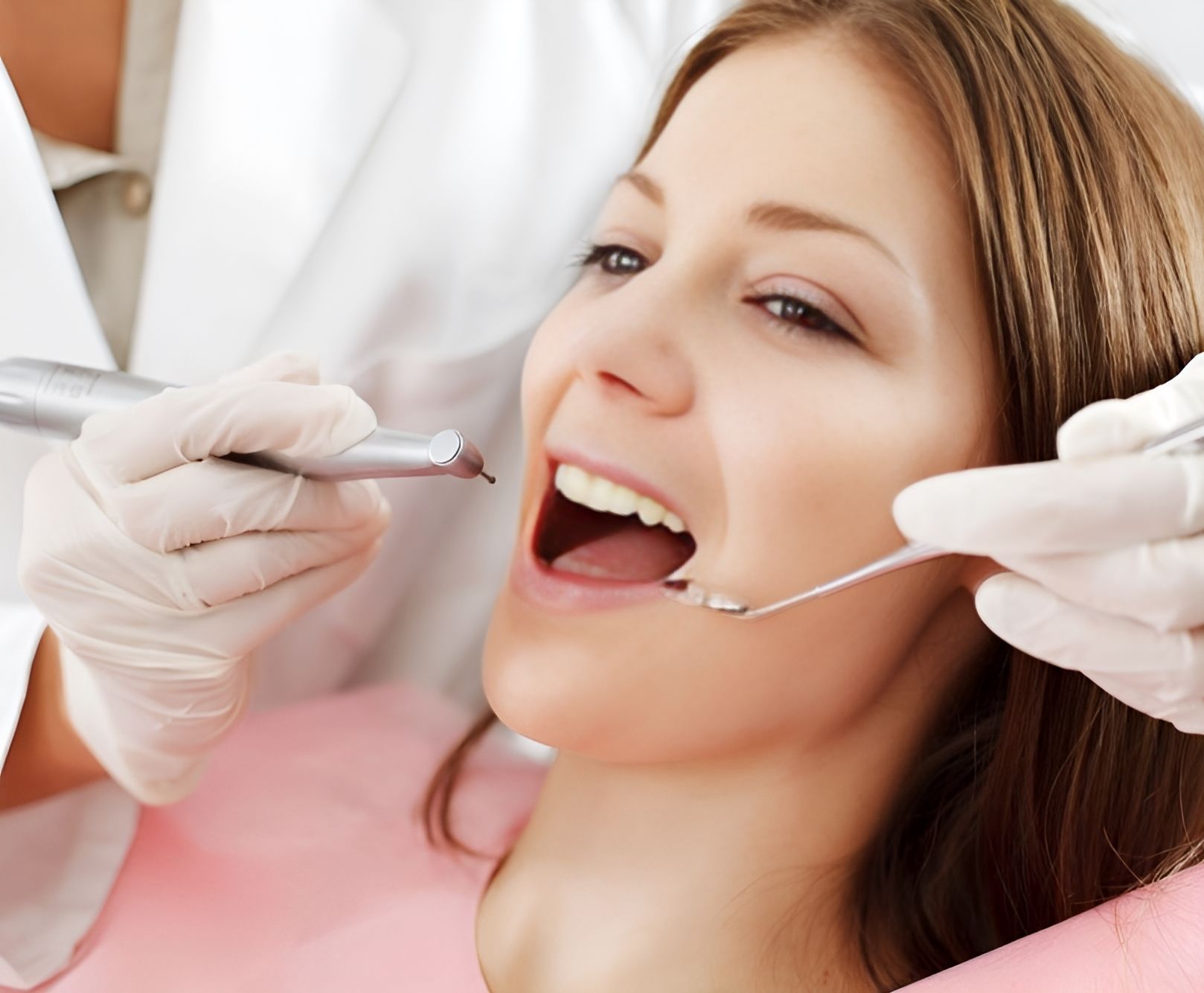 A Woman is Getting Her Teeth Examined by a Dentist — Bytes of Byron–Bio Holistic Dentistry in Byron Bay, NSW