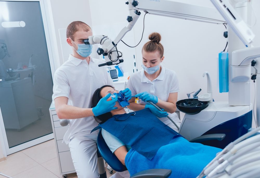 A Dentist is Examining a Patient's Teeth in a Dental Office — Bytes of Byron–Bio Holistic Dentistry in Byron Bay, NSW