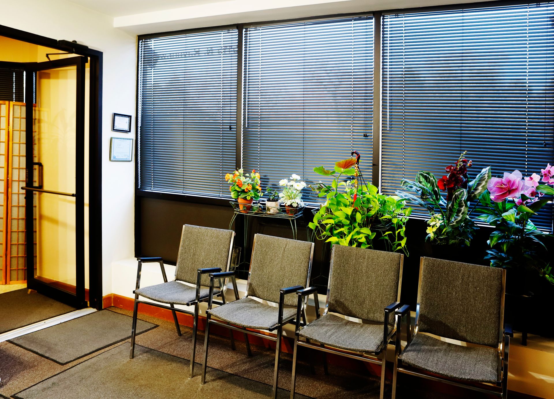 A waiting room with a lot of chairs and flowers