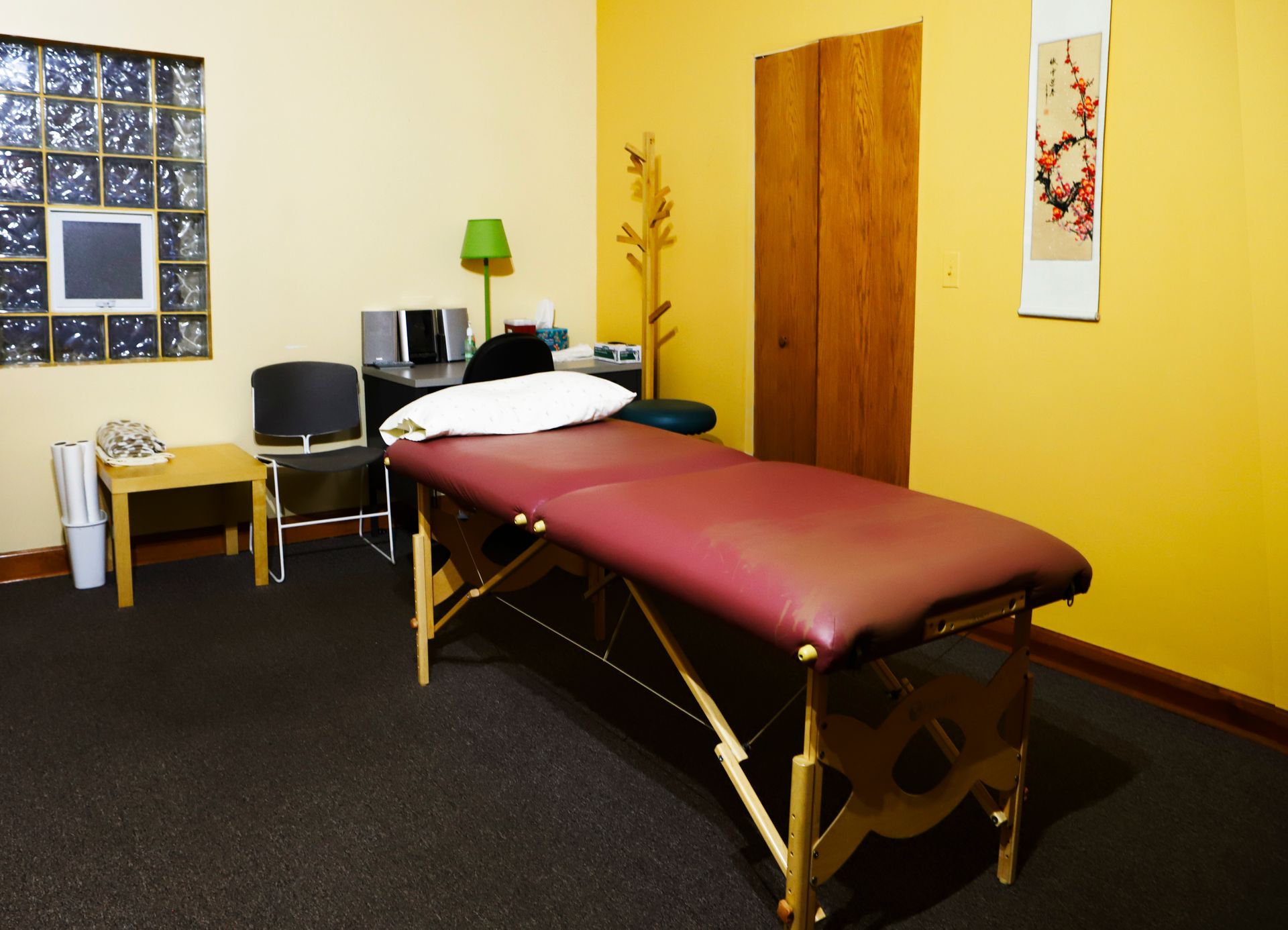 A massage table in a room with yellow walls