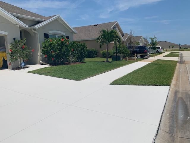 A row of houses in a residential area with a white driveway