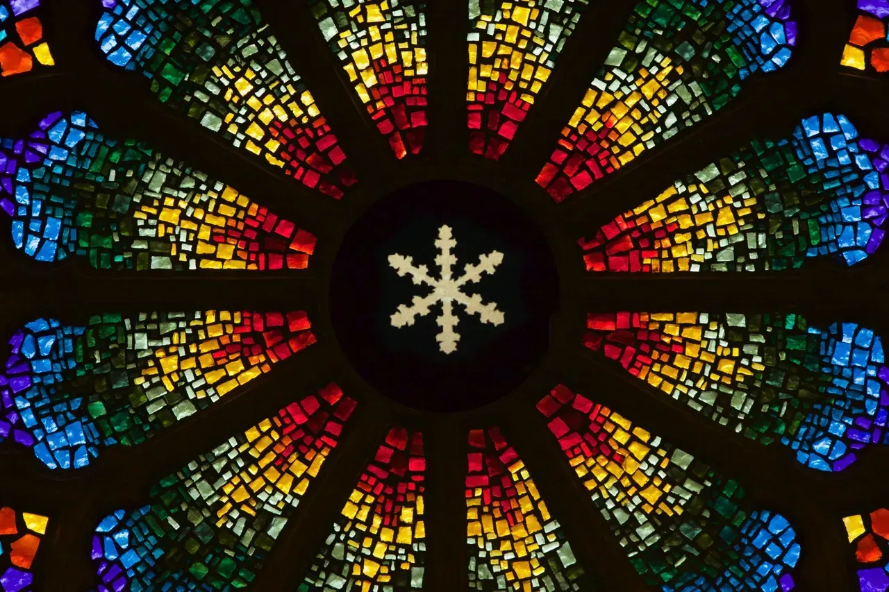 Rose Window with a simple yellow snowflake in the center.