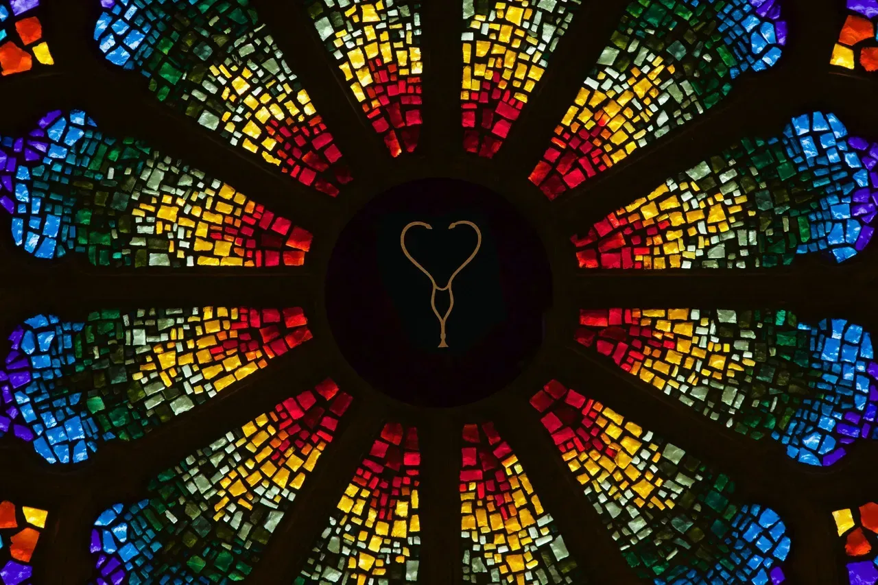 Rose window with a gold stethoscope in the center.