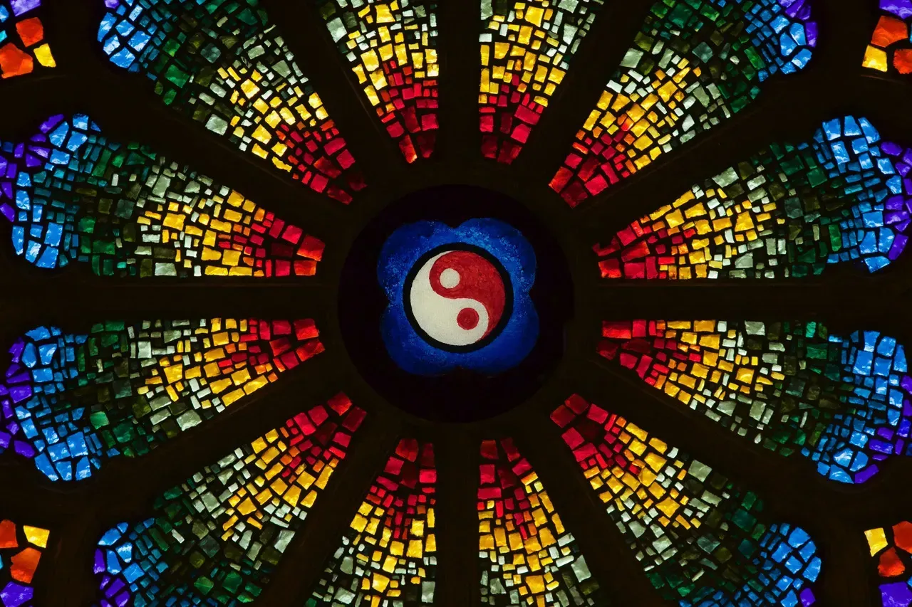 Rose window with the ying and yang symbol in the middle.
