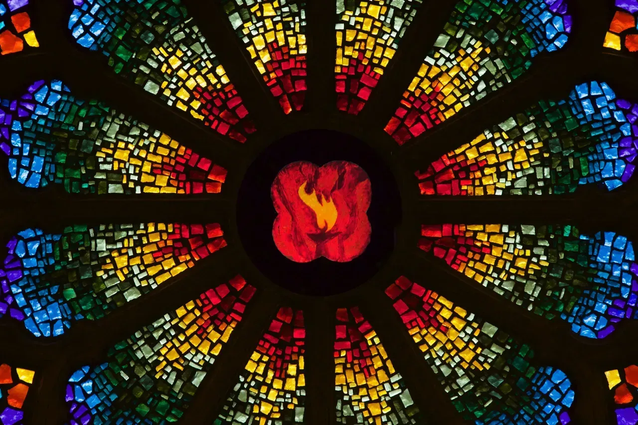 Rose Window with a Very flaming chalice in the center.