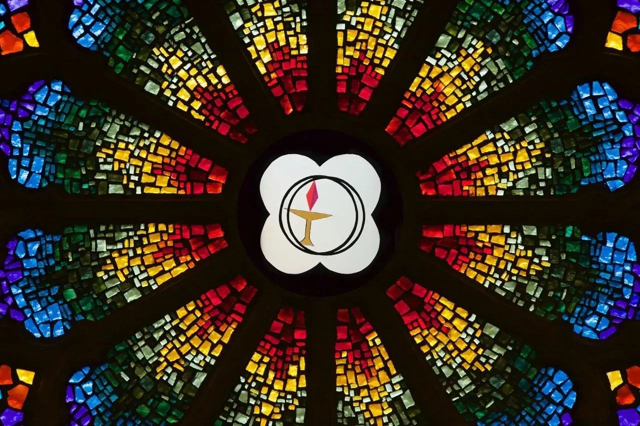 Rose Window with a circle in the center with a stylized chalice.