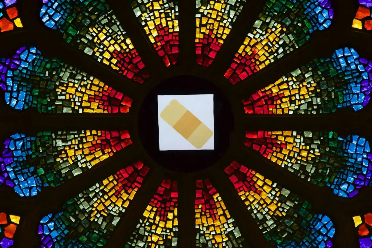 Rose window with a bandaid in the center.