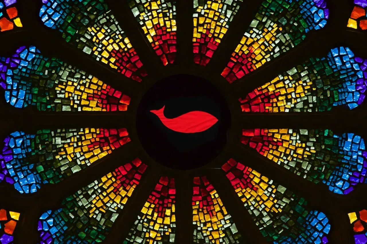 Rose window with a red whale in the center.