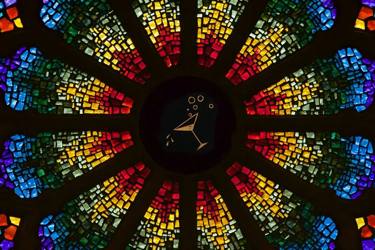 Rose window with a martini glass in the center.