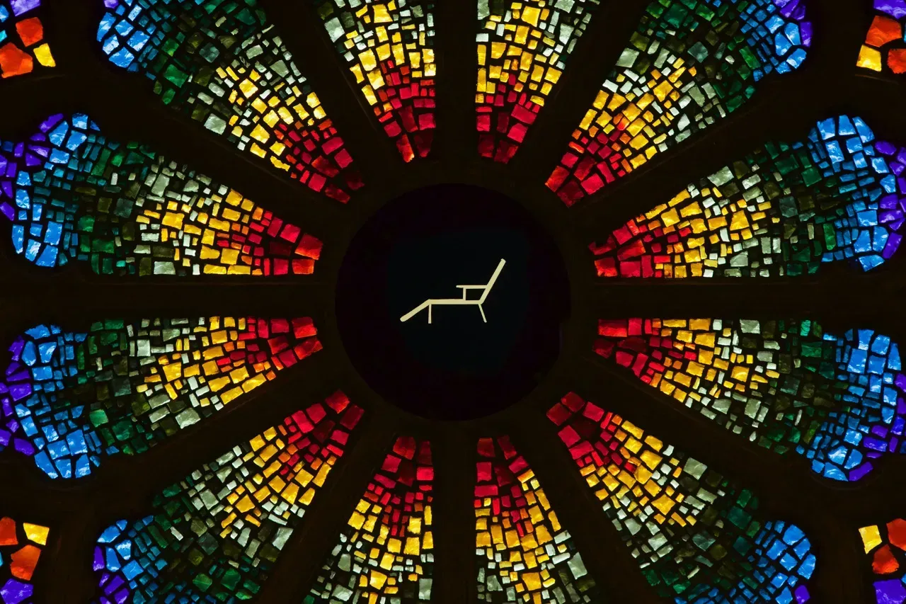Rose window with a beach chair in the center.