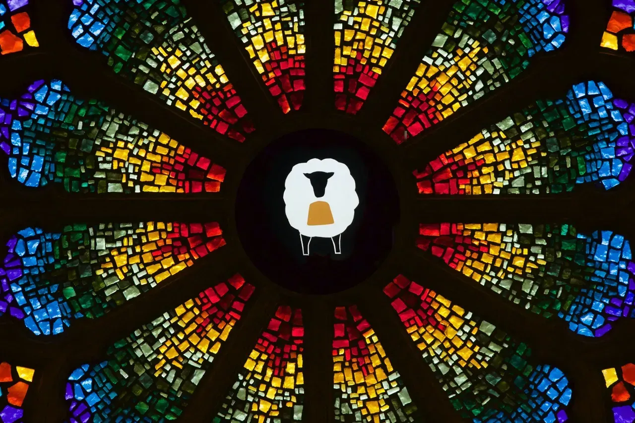 Rose window with a sheep in the center.
