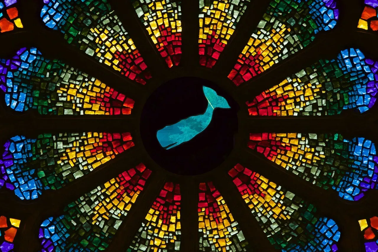 Rose window with a blue whale in the center.