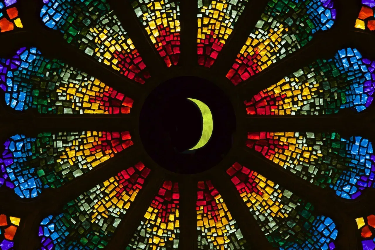 Rose window with a waxing crescent moon in the center.