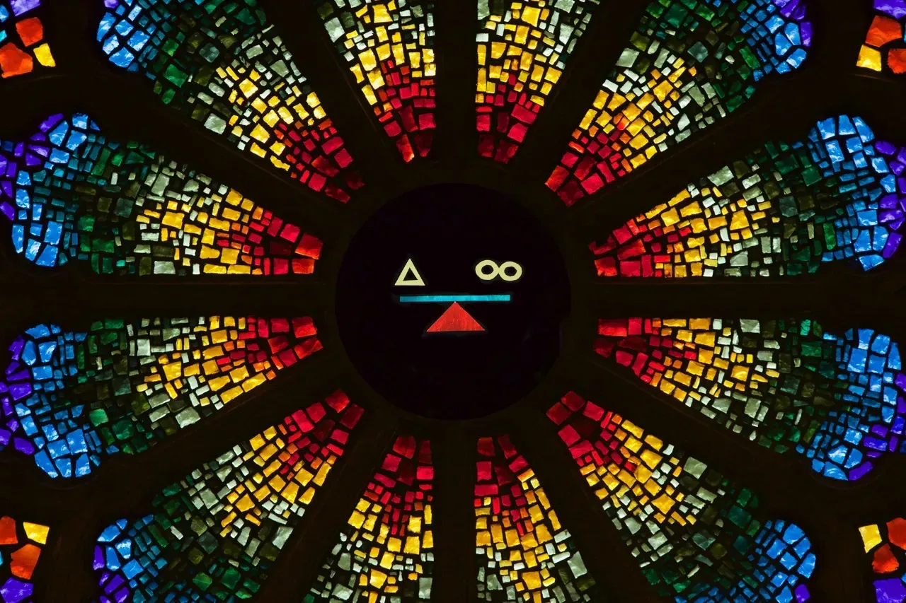 Rose Window with a scale that has a triangle on one side and 2 circles on the other.