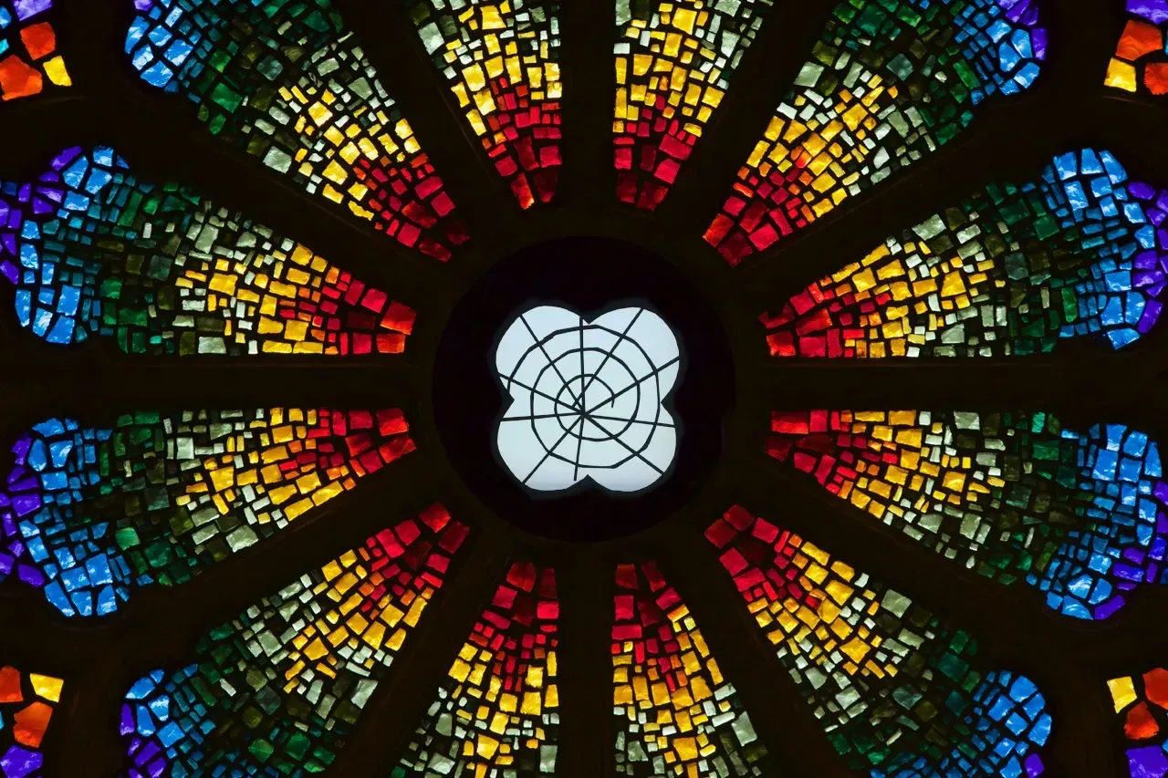 Rose Window with a spider web in the middle.