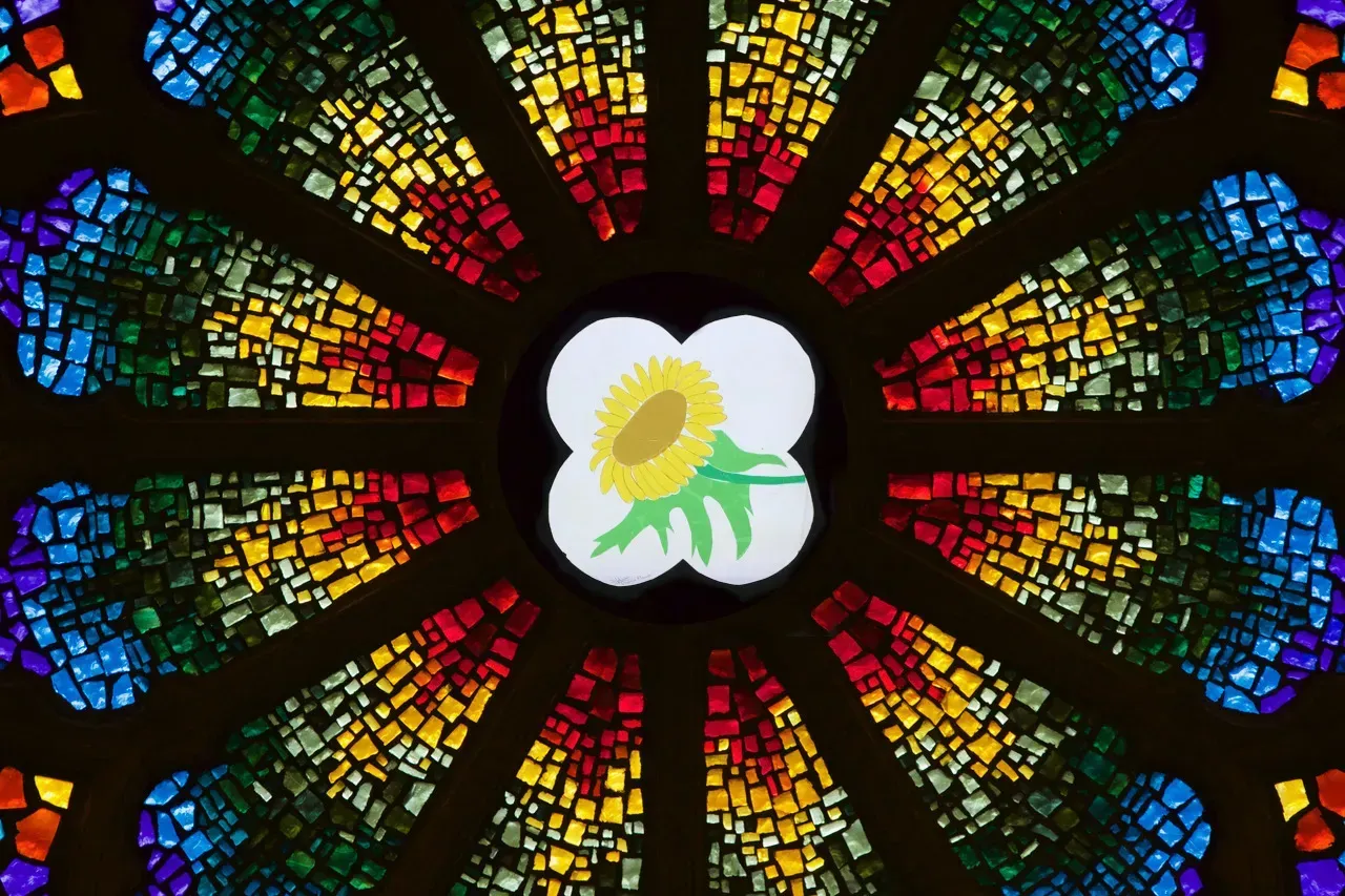 Rose window with a sunflower in the middle.