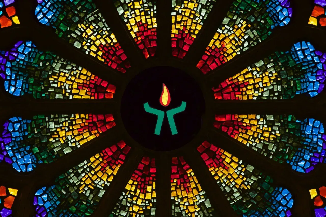 Rose window with a stylized chalice in the middle.