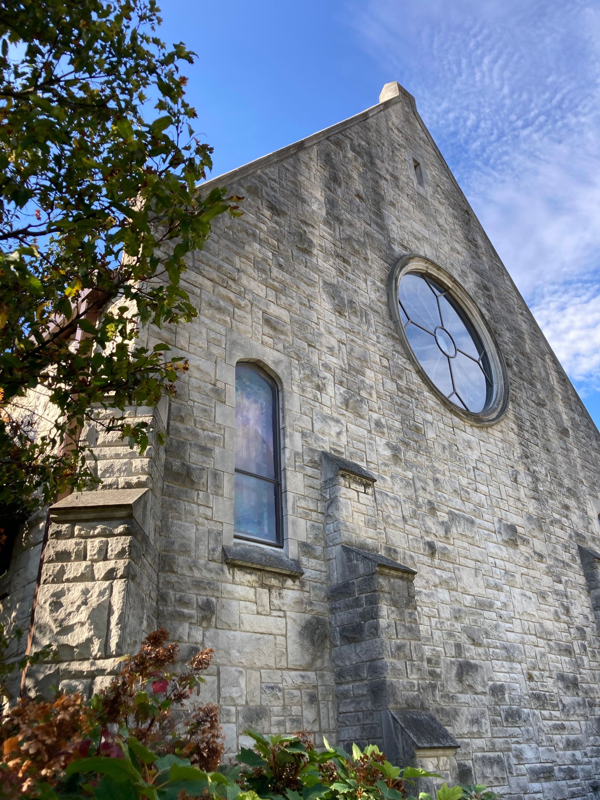 Outside of church brick building you can see the Rose Window