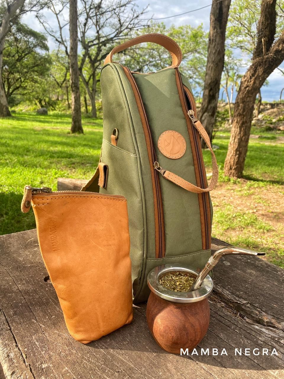 Una bolsa de tela verde para yerba mate, una bolsa de cuero color canela