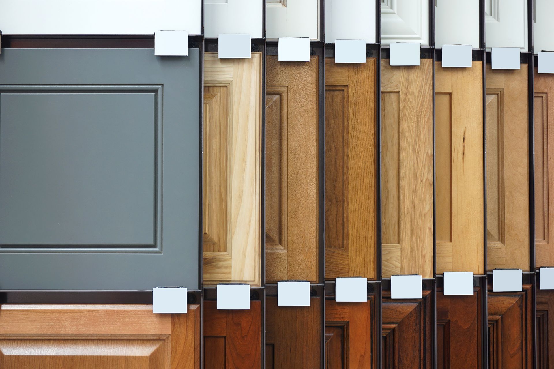 A display of different types of wooden cabinet doors in a store.