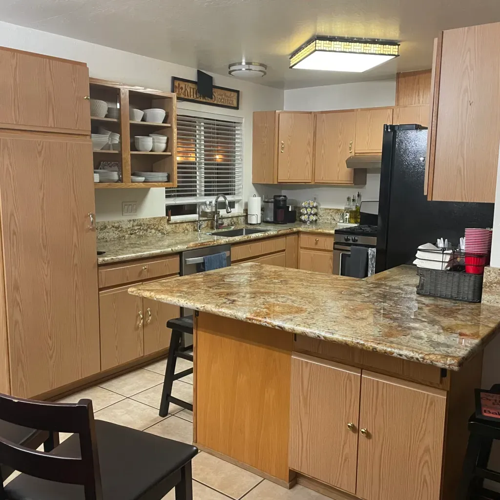 A kitchen with wooden cabinets and granite counter tops