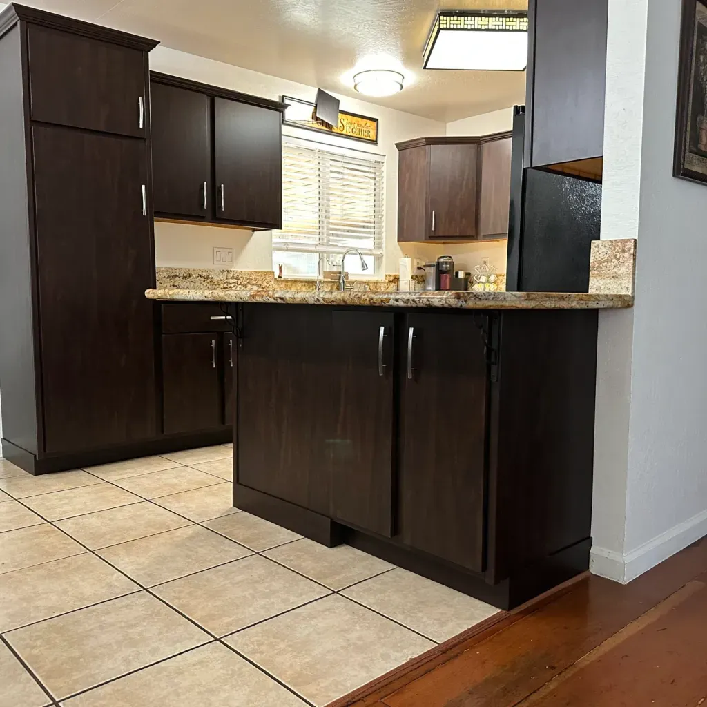 A kitchen with brown cabinets and granite counter tops